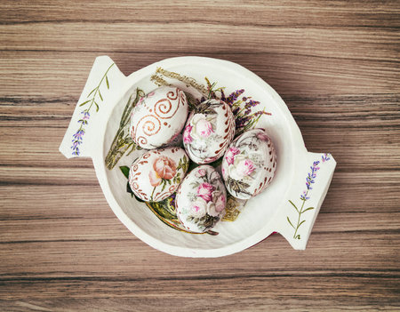 Decorative wooden bowl with painted Easter eggs. Spring time. Beautiful eastereggs.