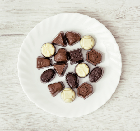 Various belgian pralines on the white plate. Sweet food theme.の写真素材