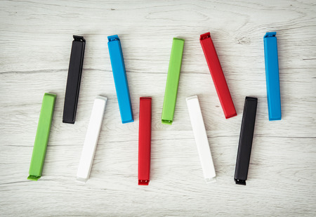 Various colorful bag clips on the wooden background.の写真素材