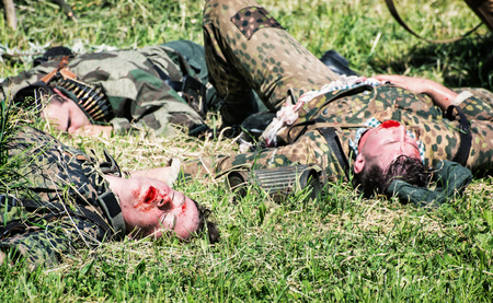 NITRA, SLOVAK REPUBLIC - MAY 21: Reconstruction of the Second World War operations Between Red and German army, group of German soldiers dead on the grass on May 21, 2016 in Nitra, Slovak Republic.のeditorial素材
