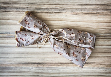 Wrapped gift on the wooden background. Holiday symbol. Surprise scene. Birthday theme. Decorative...