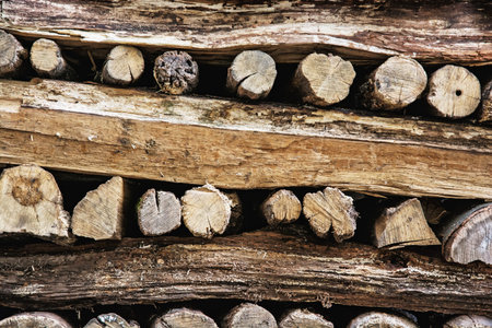 Background of stacked wooden logs. Year rings. Pile wood. Deforestation theme. Wood industry....
