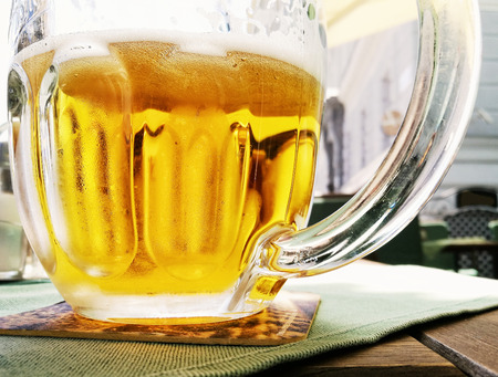 Glass of light beer. Tasty refreshment. Alcoholic drink. Glass cup on the tray. Lager beer.の写真素材