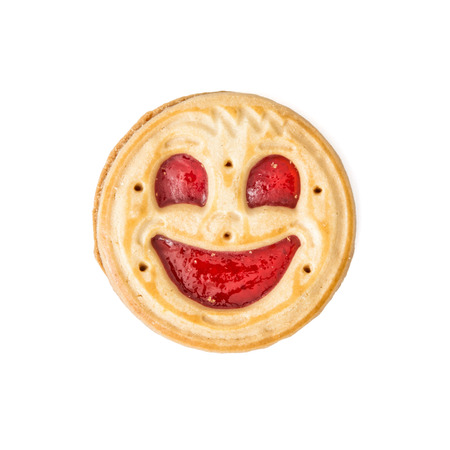Round jam biscuit smiling face isolated on the white background. Humorous sweet food. Tasty cookie. Good mood.の写真素材