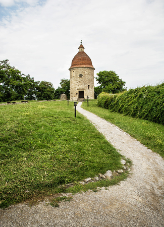 Romanesque rotunda with footpath in Skalica, Slovak republic. Architectural theme. Cultural heritage. Travel destination. Vertical composition.の写真素材