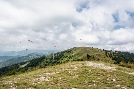 Paragliding, Donovaly, mountains scene, Slovak republic. Leisure activities. Seasonal natural theme. Beauty in nature. Adrenaline sport.の写真素材