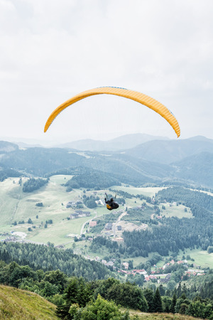 Paragliding, Donovaly, mountains scene, Slovak republic. Leisure activities. Vertical composition. Beauty in nature. Adrenaline sport.の写真素材