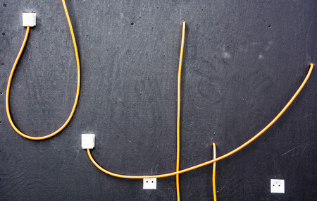 Electrical cables and sockets on the dark board. Technical training room. Education theme.の写真素材