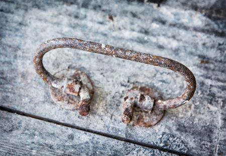 Close up of rusty knocker door. Ancient object. Retro scene.の写真素材
