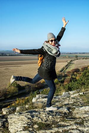 Young joyful woman posing in autumn outfit. Natural outdoors scene. Beauty and fashion. Vertical composition.の写真素材