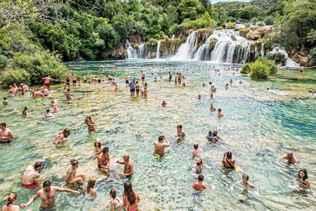 TROGIR, CROATIA â JULY 27, 2017: Many tourists are swimming in the waterfalls, Krka, Croatia, national park. Summer vacation. Travel destination. Illustrative editorial.のeditorial素材