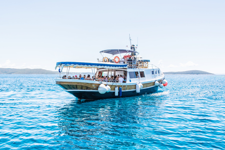 DRVENIK VELI, CROATIAâ JULY 26, 2017: Many tourists on the cruise ship in Blue Lagoon, Drvenik Veli, Adriatic Sea, Croatia. Travel destination. Summer vacation. Illustrative editorial.のeditorial素材