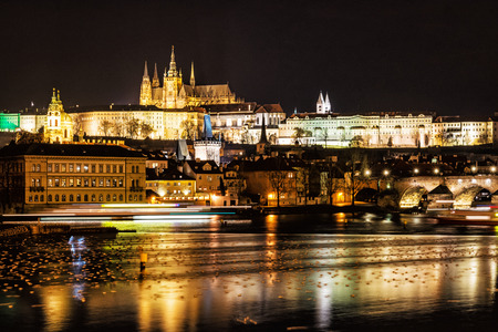 Famous castle and Charles bridge mirroring in Vltava river, Prague, Czech republic. Night scene. Travel destination. Architectural scene.のeditorial素材