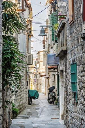 Narrow street in historic town Trogir, Croatia. Morning scene. Travel destination.の写真素材