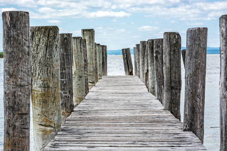 Wooden pier in Podersdorf am See, lake Neusiedler See, Burgenland, Austria. Travelling theme.の写真素材