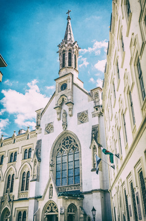 Roman catholic church in Sopron, Hungary. Religious architecture. Travel destination. Analog photo filter with scratches.の写真素材