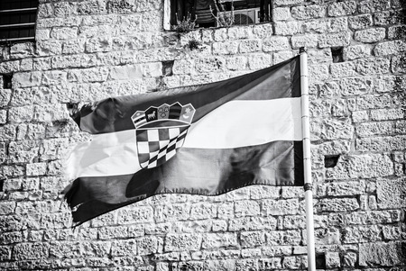 Croatian flag on stone background. Symbolic object. Black and white photo.の写真素材