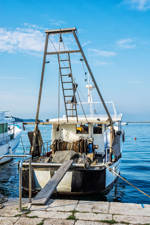 Fishing boat with nets in port, Porec, Istria, Croatia. Mediterranean Sea scene. Travel destination.の写真素材