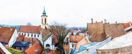 Annunciation church and red roofs of old houses, Szentendre, Hungary. Religious architecture. Panoramic scene. Place of worship. Vivid photo filter.の写真素材