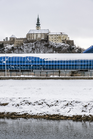 Castle, football stadium and river in Nitra, Slovak republic. Winter scene. Travel destination.のeditorial素材