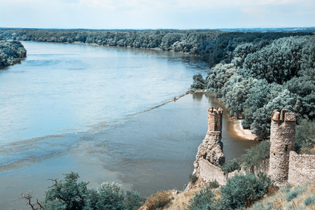 Maiden tower of Devin castle and confluence of the Danube with Morava rivers. Slovak republic, central Europe. Teal and orange photo filter.の写真素材