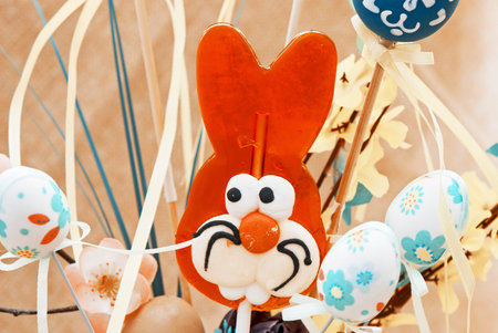 Lollipop-shaped Easter Bunny with painted eggs. Teal and orange photo filter.