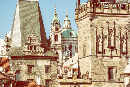 Lesser town bridge tower and St. Nicholas Church, Prague, Czech republic. Travel destination. Architectural scene. Yellow photo filter.の写真素材
