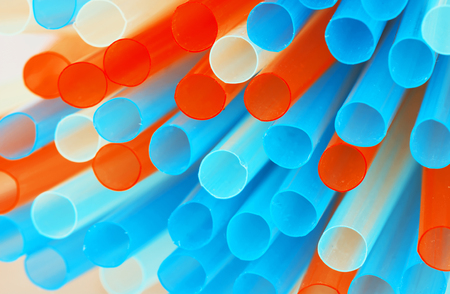 Mix of plastic colored drinking straws. Teal and orange photo filter.の写真素材