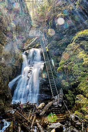 Big waterfall in Velky Sokol gorge, Slovak Paradise national park. Seasonal natural scene. Long time...