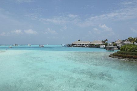 Luxury resort in Maldives. Woter bungalo in blue sea.Some white boats.の写真素材
