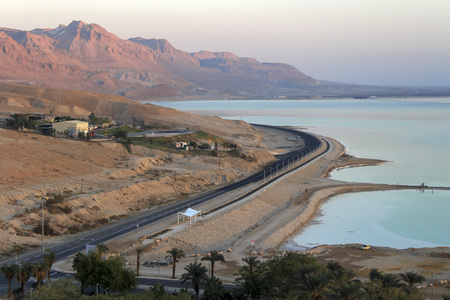 The road between  pink mountains sea in sunrise on Dead seaの写真素材