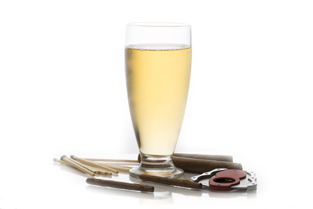 Glass of beer surrounded by cuban cigars matches and cigar cutterの写真素材