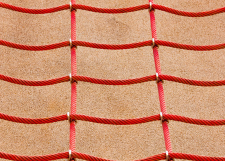 Red wire netting on concrete backgroundの写真素材