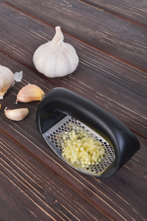 Garlic press and cloves of garlicの写真素材
