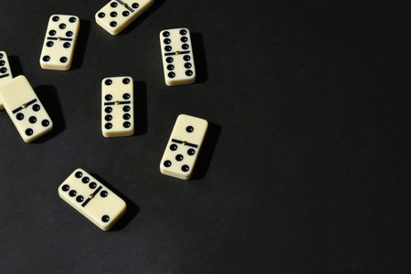 Dominoes on black background. Top view. Copy space.の写真素材