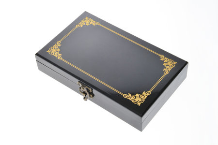 Black box with gold pattern isolated on white background, clipping path included