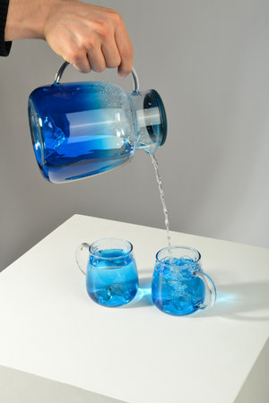 Pour water into a blue glassの写真素材