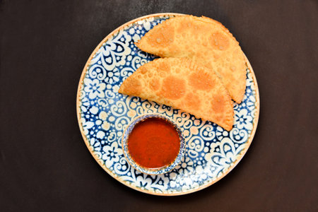 Russian cuisine is tasty chebureki fried dough with meat.