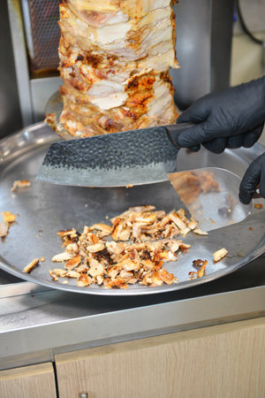 Doner kebab is fried in a frying pan in the kitchenの写真素材