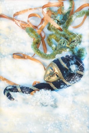 two masks in the snow with Christmas ornaments の写真素材