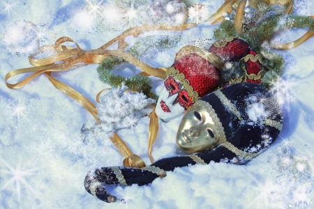 two masks in the snow with Christmas ornaments の写真素材