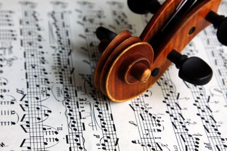 The scroll of an old Italian violin on sheet music.の写真素材