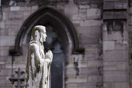 A sculpture of a praying saint の写真素材
