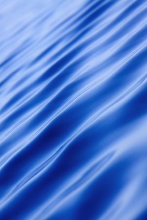 An abstract background image with some waves on calm water.の写真素材