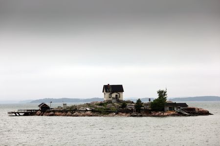 An isolated home on a very small island.の写真素材