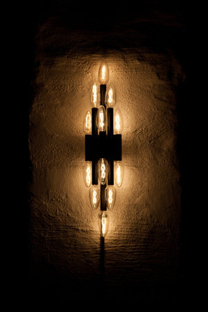 A symmetrical cluster of candle-shaped light bulbs.