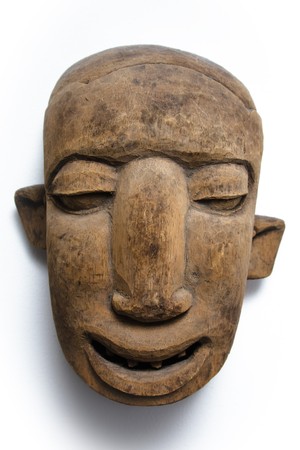 A wooden african face mask with asymmetric ears, shot on white background.の写真素材