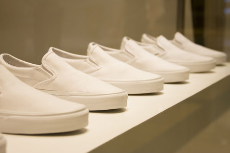 Roll of identical men's deck shoes on display.