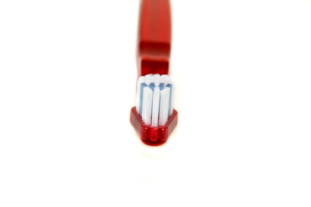 Red toothbrush isolated on a white background.