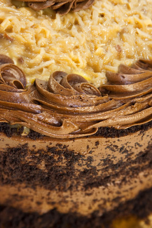 German Chocolate cake and icing topped with red cherry.